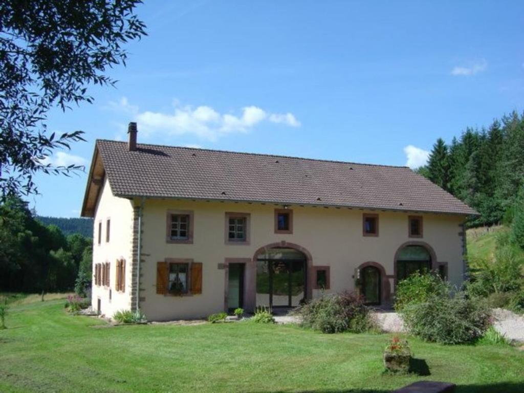 a large white house with a green yard at Gîte Taintrux, 5 pièces, 10 personnes - FR-1-589-232 in Taintrux