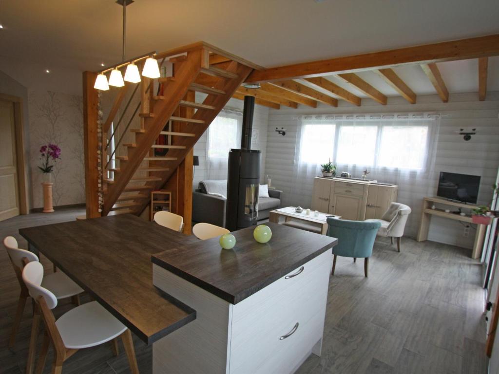 a kitchen and living room with a table and a staircase at Gîte Chamagne, 3 pièces, 4 personnes - FR-1-589-11 