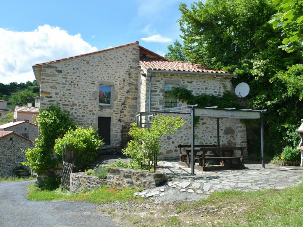 une maison en pierre avec une table de pique-nique devant elle dans l'établissement Gîte Langeac, 3 pièces, 4 personnes - FR-1-582-124, à Langeac