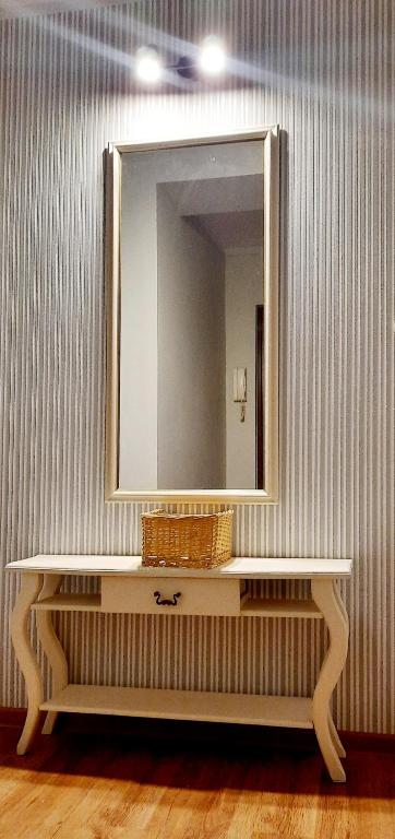 a mirror on top of a white table in a room at Mokka Apartament in Kielce