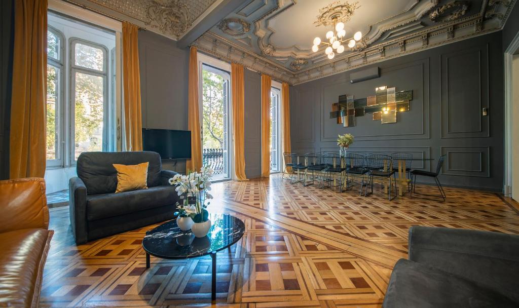 a living room with a couch and a table at You Stylish City Center Apartments in Barcelona