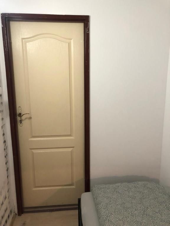 a white door with a wooden frame next to a bed at NR 4 in Krakow