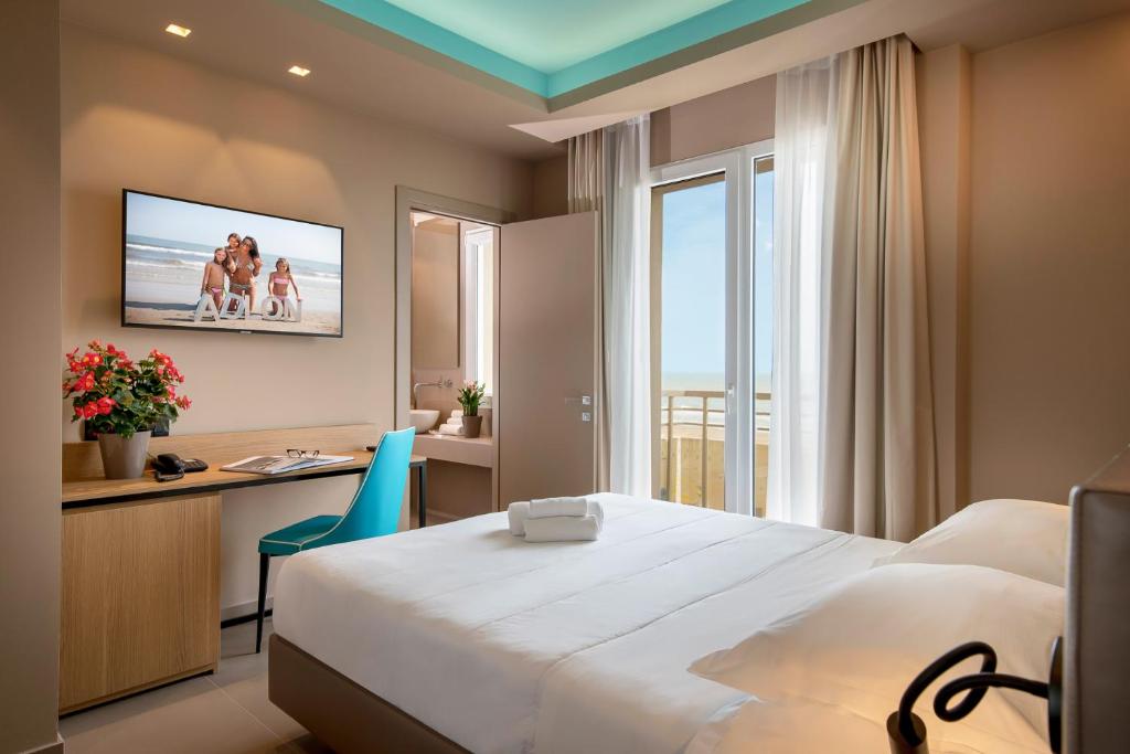 Postel nebo postele na pokoji v ubytování Hotel Adlon - FRONTE MARE