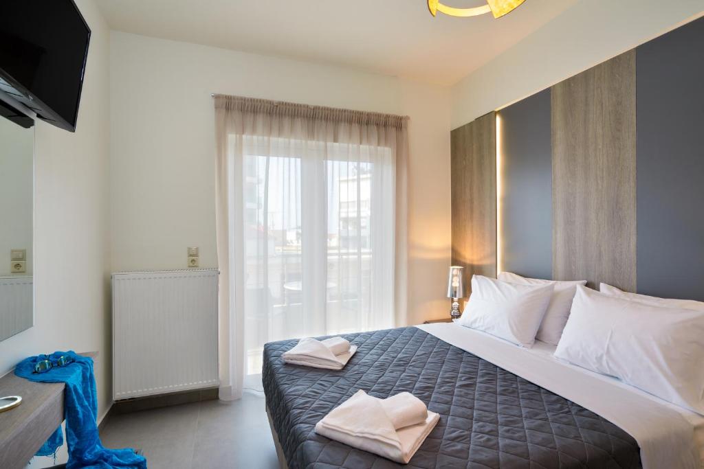 Łóżko lub łóżka w pokoju w obiekcie Elia Residences