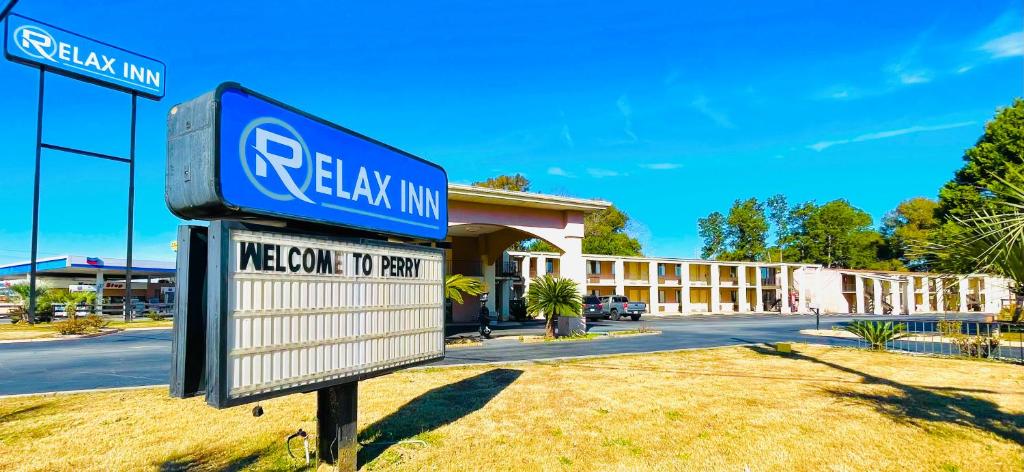 a sign in front of a building at Relax Inn - Perry in Perry