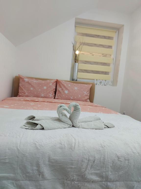 a bedroom with a bed with towels on it at Apartman Nika in Pale