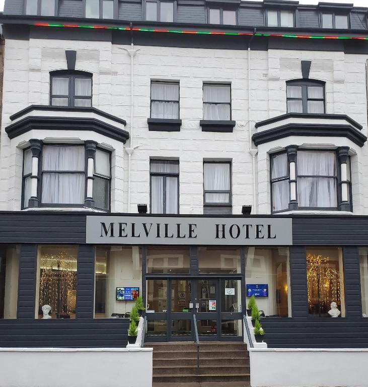 a white building with a melville hotel sign on it at The Melville Hotel in Blackpool