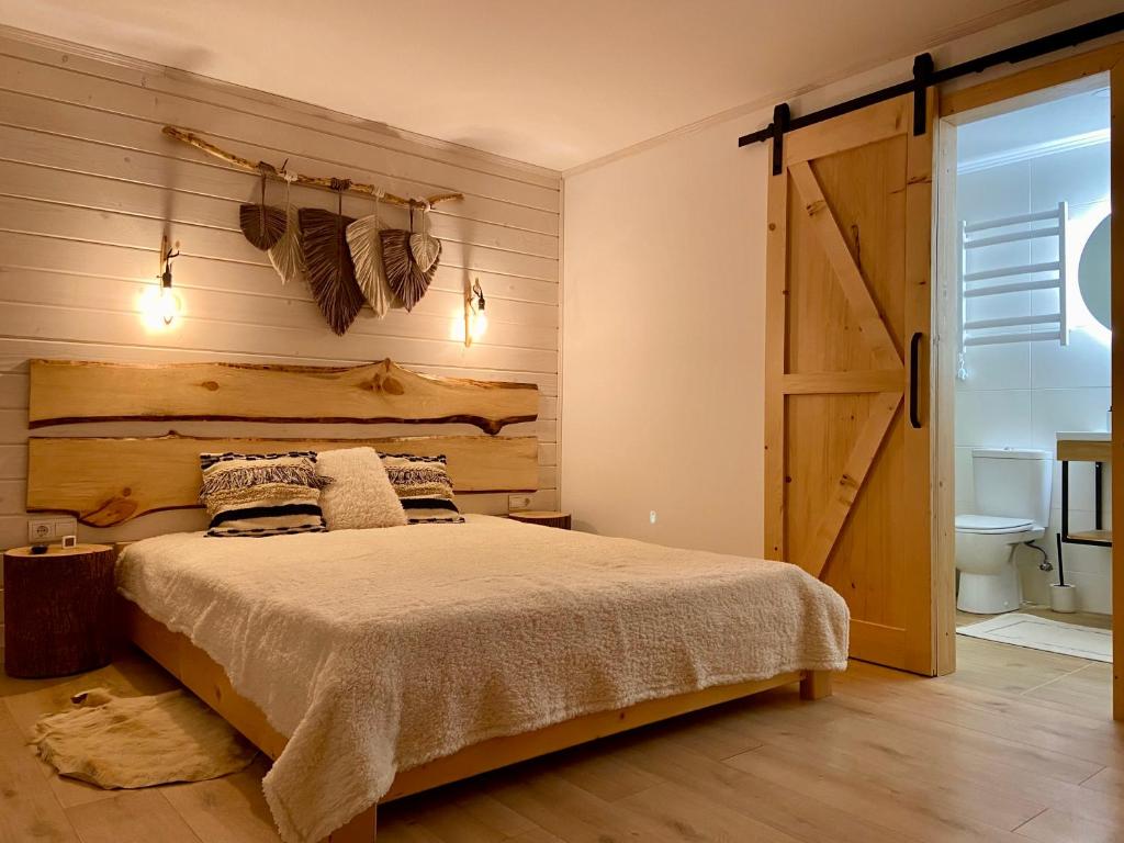 um quarto com uma cama e uma porta de correr no celeiro em Shepit Pruta em Yaremche