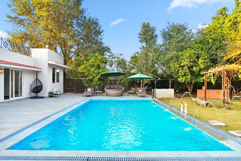The swimming pool at or near Mulberry Farms - Luxury Villa with Private Pool