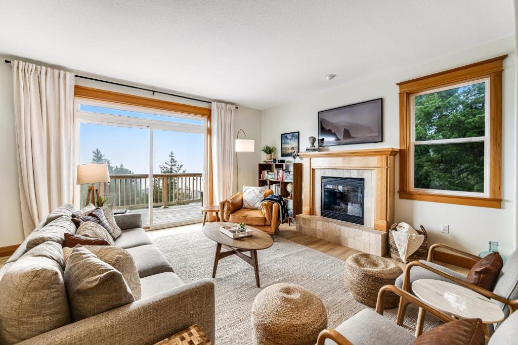 a living room with a couch and a fireplace at Three Capes Bungalow in Oceanside
