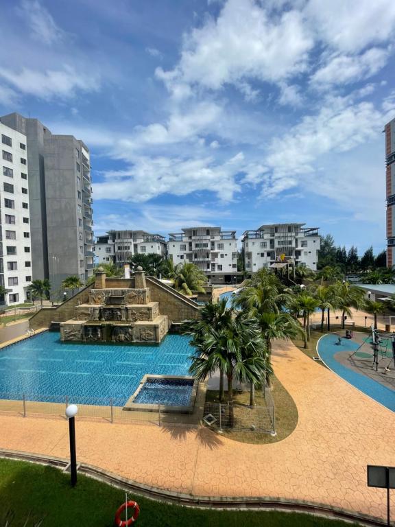 a view of a swimming pool with buildings in the background at Pool View Water Theme Park at Swiss Garden Residence - 2 bedroom apartment in Kuantan