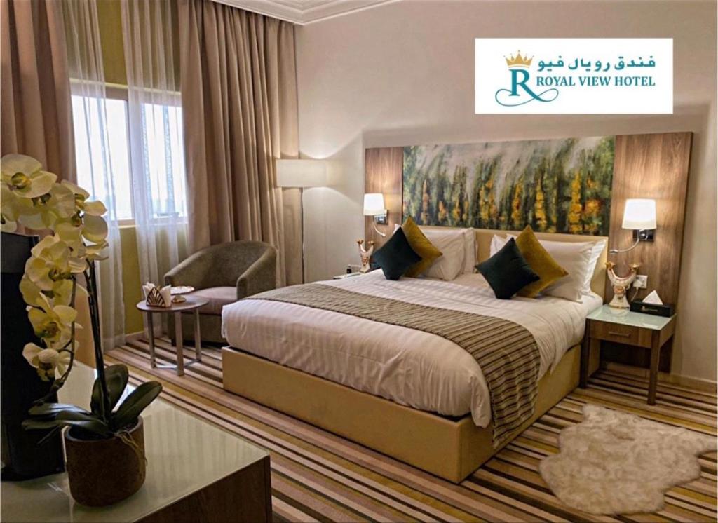 a hotel room with a bed and a large window at Royal View Hotel in Ras al Khaimah