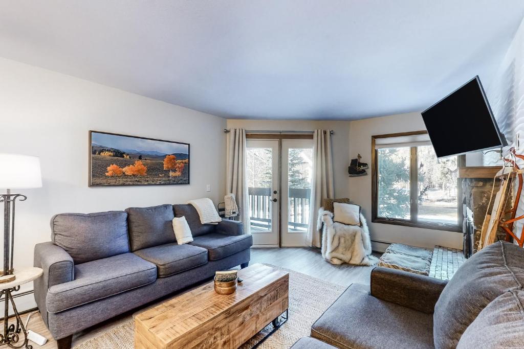 a living room with a couch and a table at Copper Valley 107 in Copper Mountain