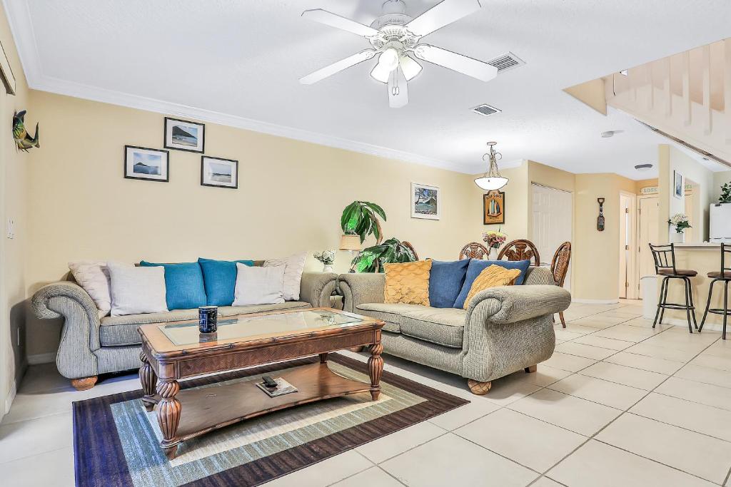 a living room with two couches and a coffee table at Sandy Nose in Cape Canaveral