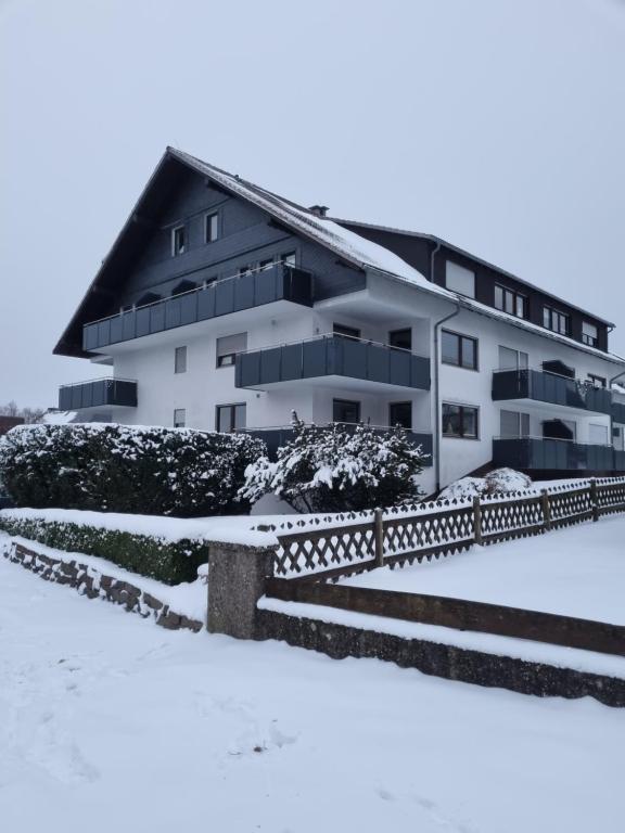 a building with snow in front of it at Ferienwohnung Schanzenblick in Winterberg