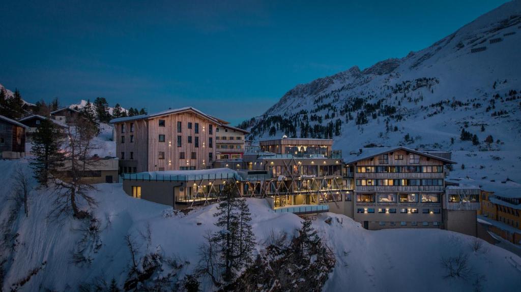 a large building in the snow at night at Das Kohlmayr Superior in Obertauern