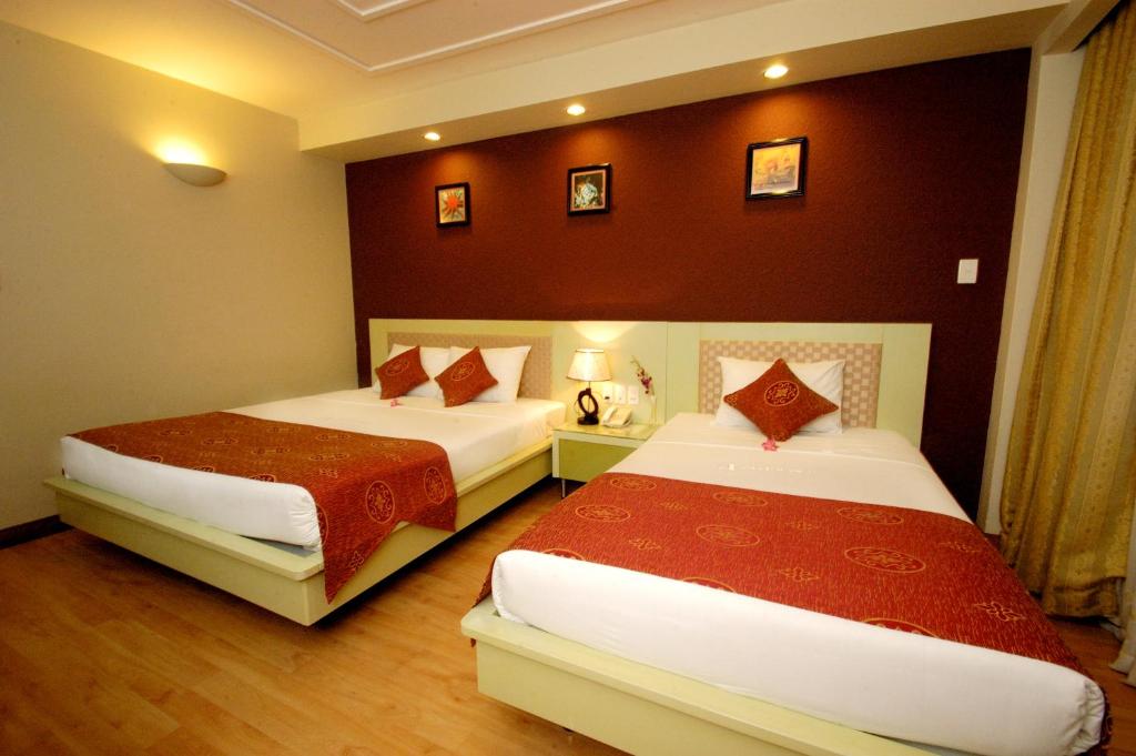 Postel nebo postele na pokoji v ubytování Asia Paradise Hotel