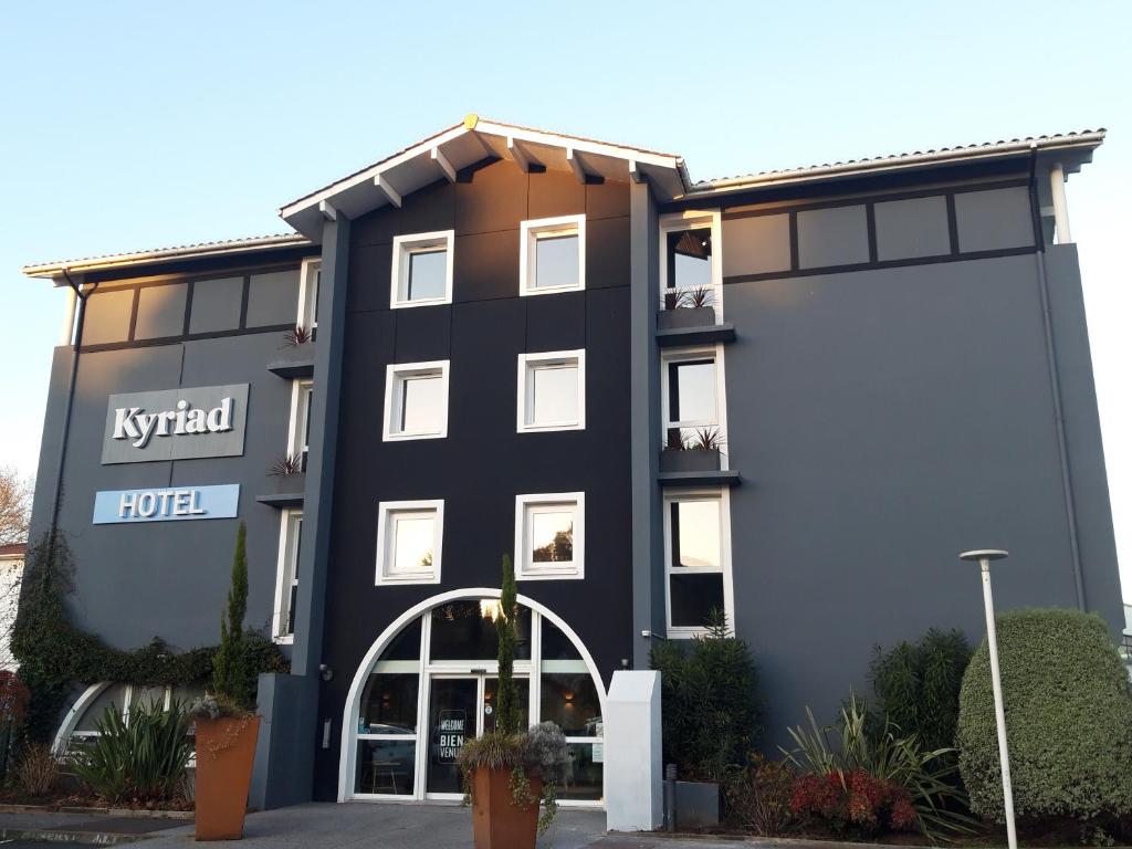 a black and white building with a hotel at Kyriad Anglet - Biarritz in Anglet