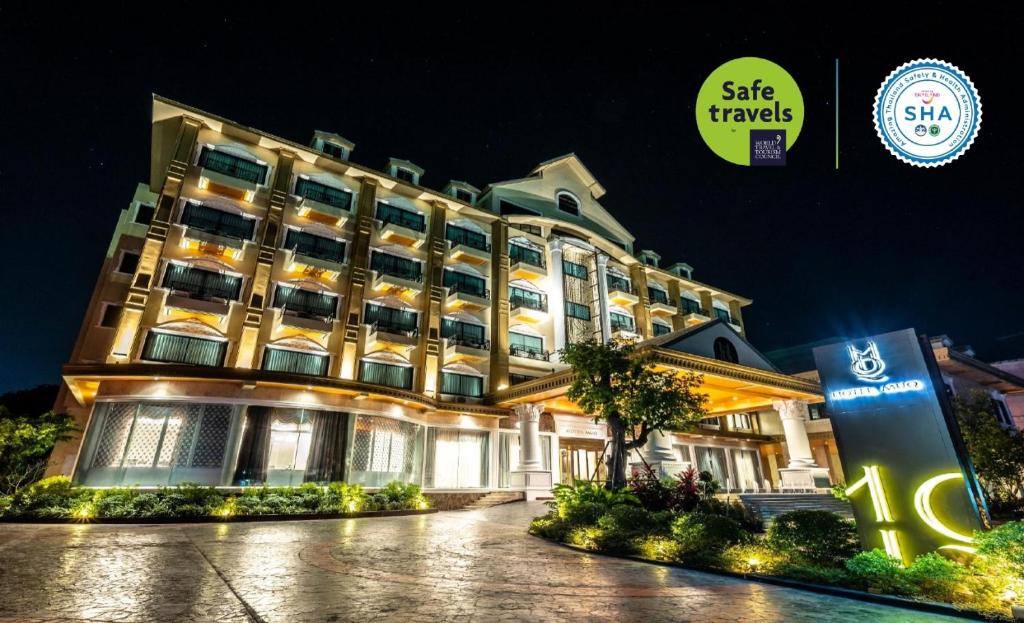 a hotel building with a sign in front of it at โฮเทลมุก in Mukdahan