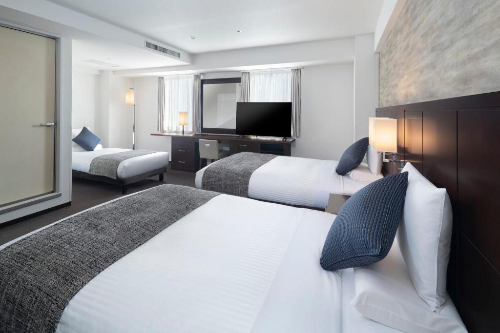 Postel nebo postele na pokoji v ubytování ART HOTEL Nippori Lungwood