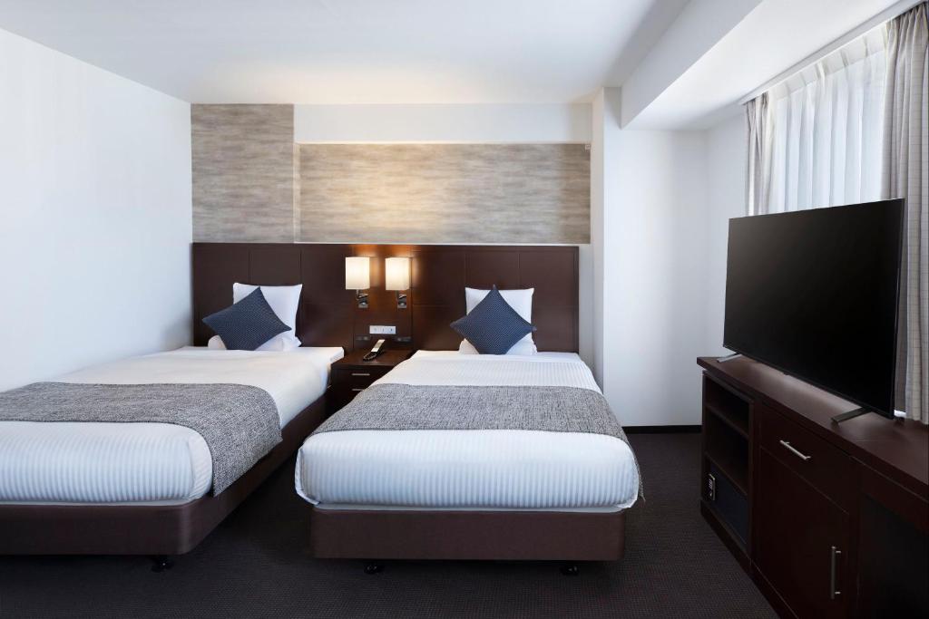 Postel nebo postele na pokoji v ubytování ART HOTEL Nippori Lungwood
