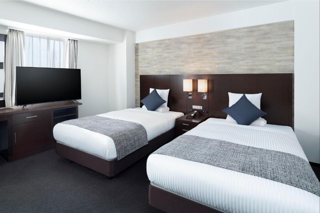 Postel nebo postele na pokoji v ubytování ART HOTEL Nippori Lungwood