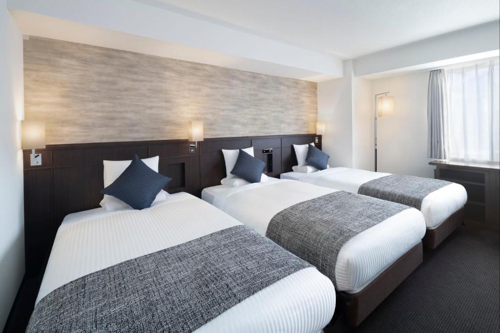 Postel nebo postele na pokoji v ubytování ART HOTEL Nippori Lungwood