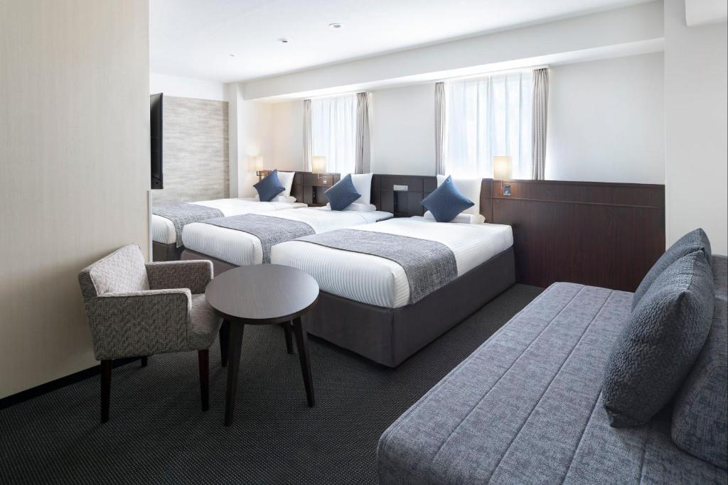 Postel nebo postele na pokoji v ubytování ART HOTEL Nippori Lungwood