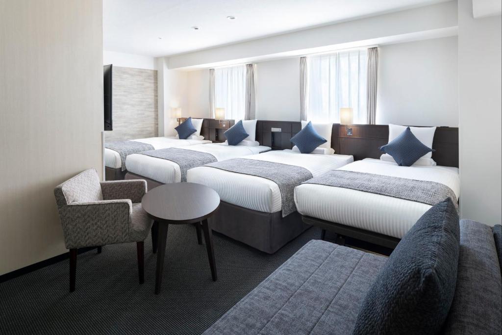Postel nebo postele na pokoji v ubytování ART HOTEL Nippori Lungwood