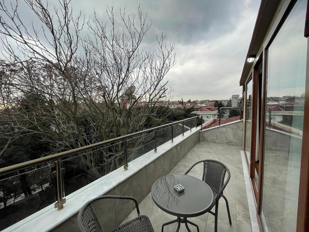 a patio with a table and chairs on a balcony at BayMari Suites Plus Florya in Istanbul