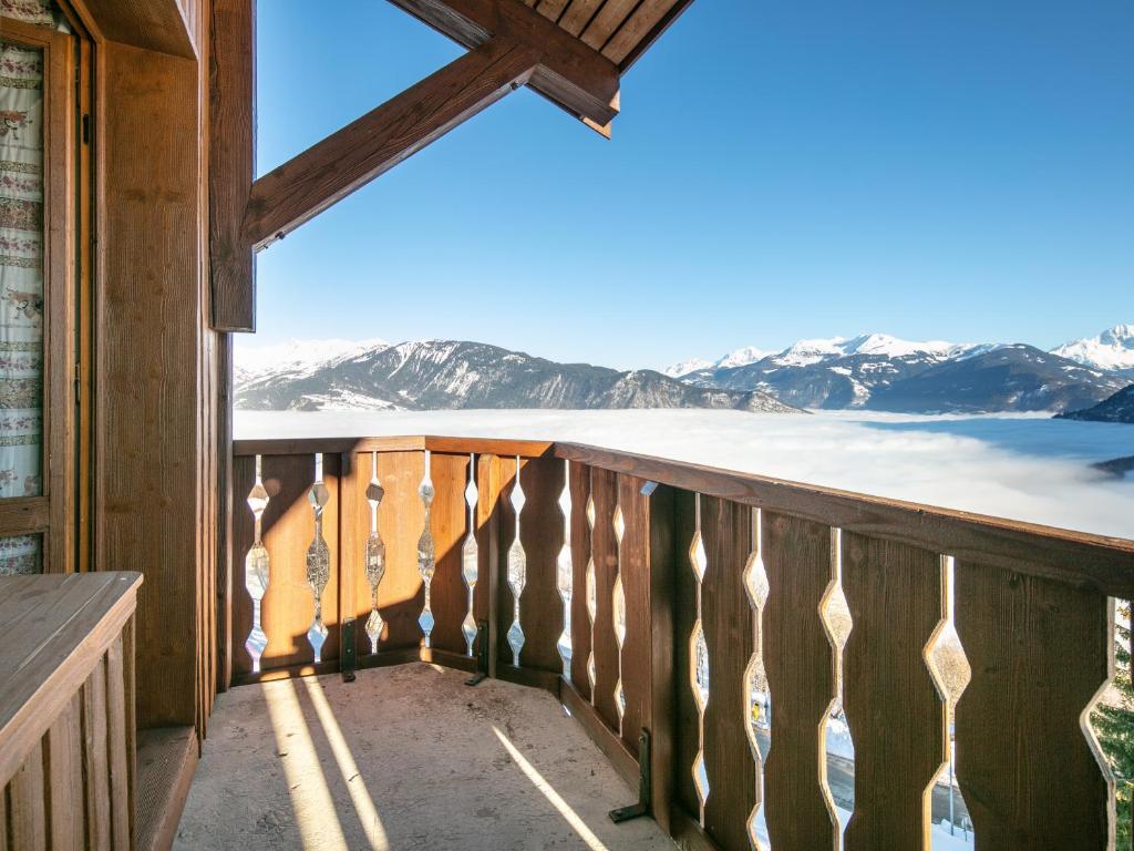 a balcony with a view of the snow covered mountains at Vacancéole - Résidence Le Sappey - Doucy in La Léchère