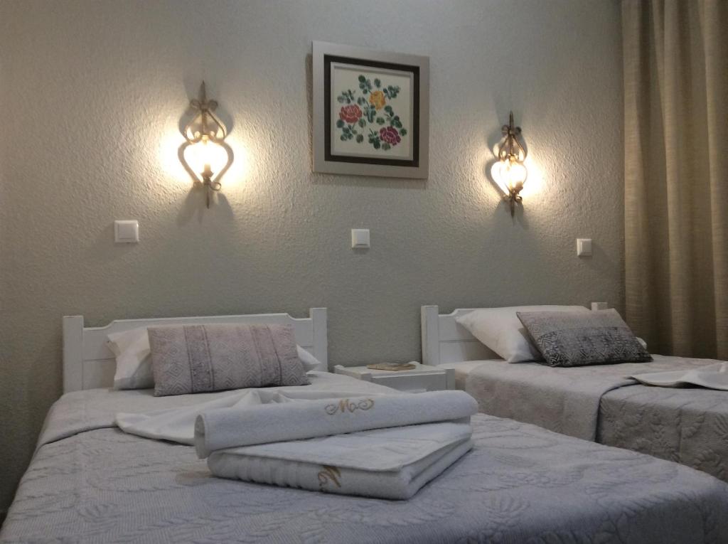 Postel nebo postele na pokoji v ubytování Maria Suites