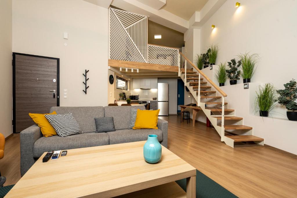 a living room with a couch and a staircase at City Center Ground Loft - Ioannina in Ioannina