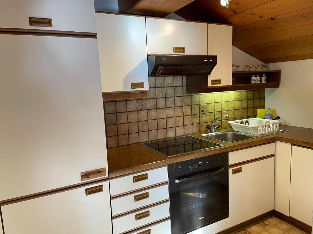 a kitchen with a sink and a stove top oven at Appartement Oberlacken in Sankt Johann in Tirol
