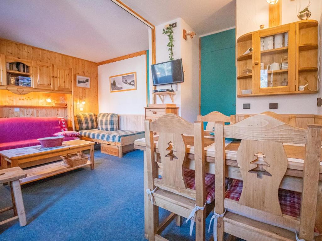 a living room with wooden furniture and a couch at Appartement Valmorel, 1 pièce, 4 personnes - FR-1-356-194 in Valmorel