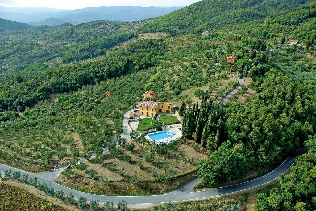 an aerial view of a house on a hill with a road at Podere San Martino in Montevettolini