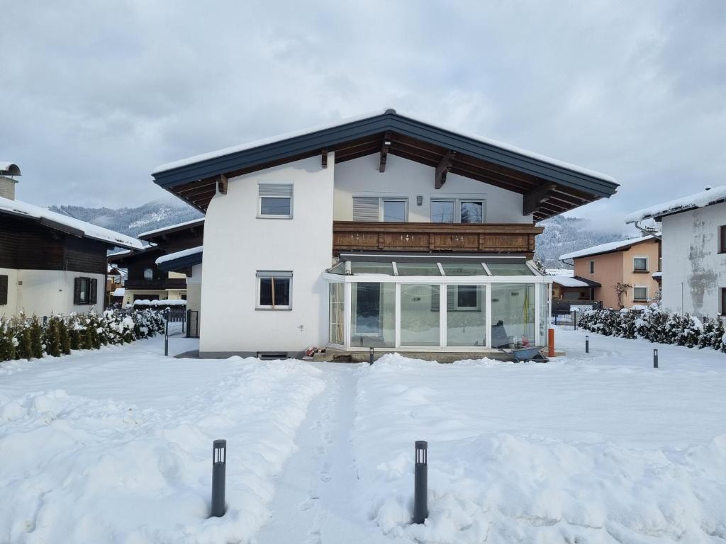 a house with snow in front of it at Spa Chalet by we rent in Zell am See