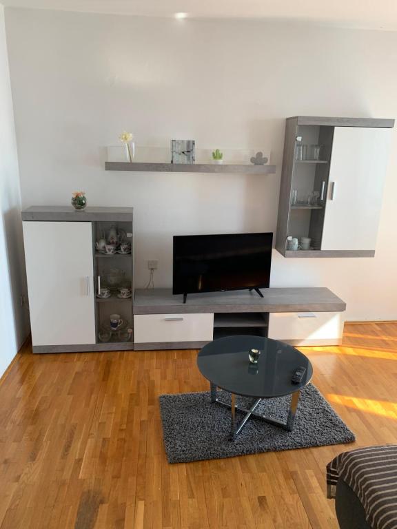 a living room with a tv and a table at Apartment Ivanka in Senj