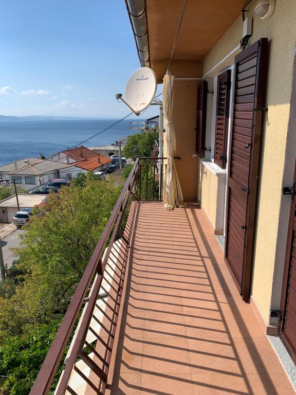 a balcony of a house with a view of the ocean at Apartment Ivanka in Senj