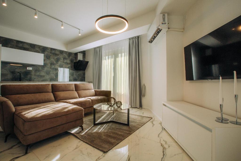 a living room with a couch and a tv at Central Apartment Chunarot in Ohrid