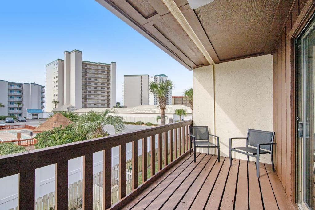 two chairs on a balcony with a view of a city at Blue Shores in Panama City Beach