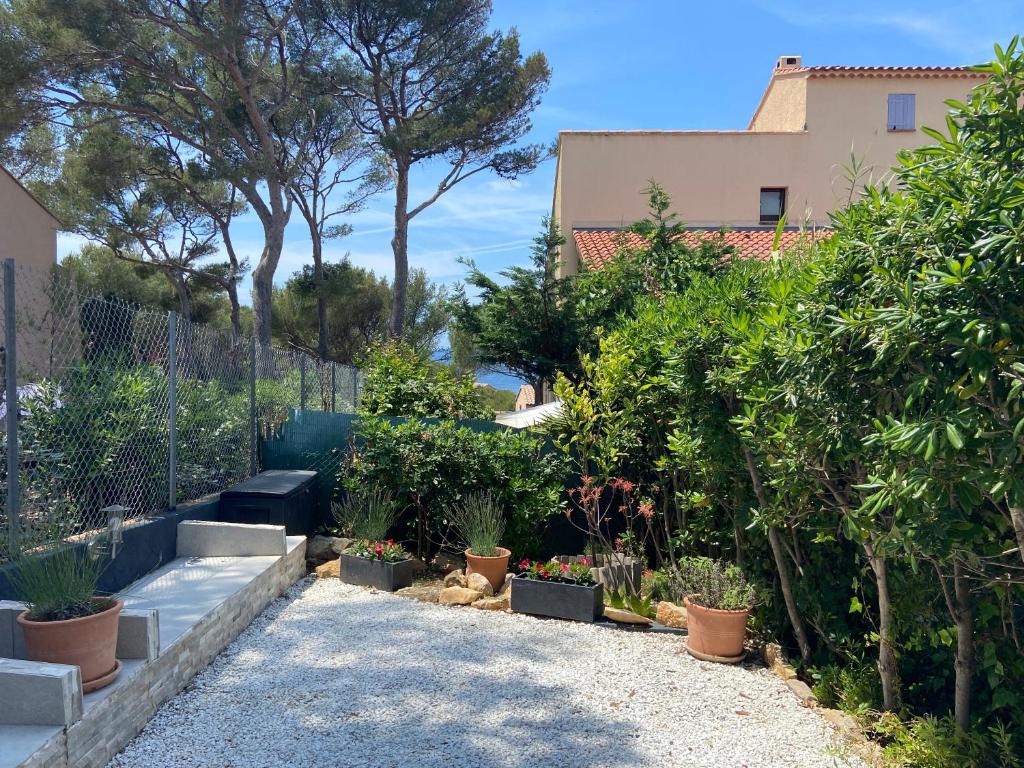um jardim com vasos de plantas e uma cerca em Logement entier T2 climatisé, parking gratuit, jardin, mer em Sanary-sur-Mer