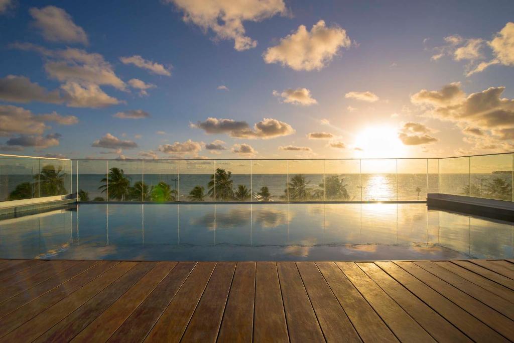 a swimming pool on top of a building at Infinity at the Sea by Welkom in João Pessoa