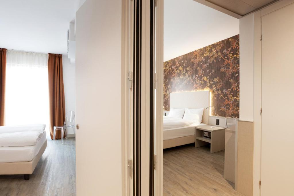 a bedroom with a bed and a painting on the wall at Hotel Internazionale Bellinzona in Bellinzona