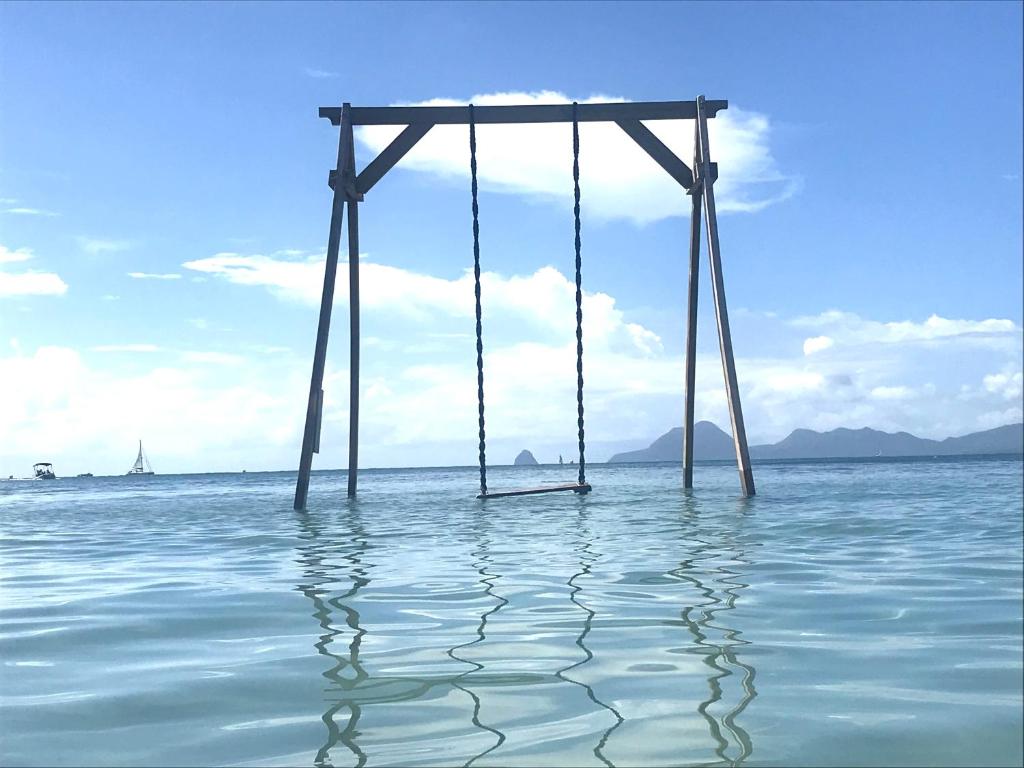 a swing in the middle of the water at studio Sainte Anne 2mn a pieds de la plage ,possibilité location de voiture CV acceptés in Sainte-Anne