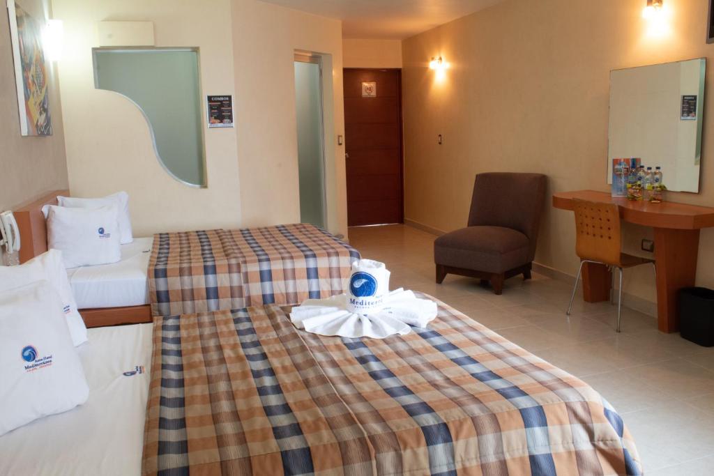 Postel nebo postele na pokoji v ubytování Auto Hotel Mediterráneo