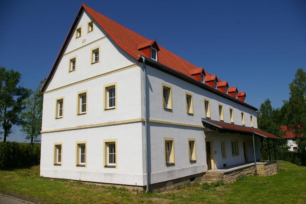 a large white house with a red roof at Apartmány Růžová in Růžová