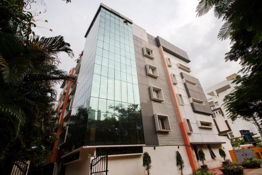 a building with glass windows on the side of it at Way Inns in Hyderabad