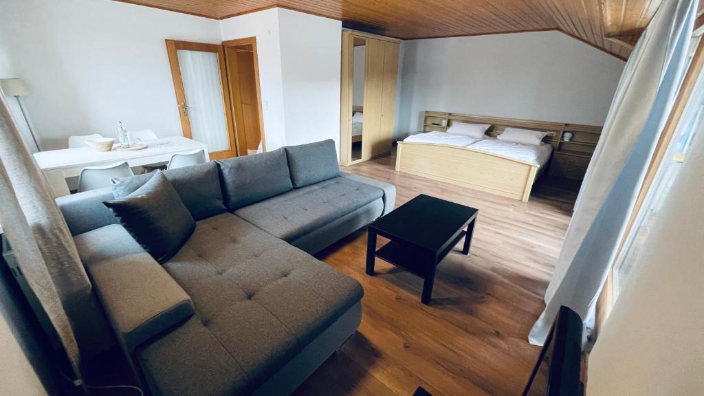 uma sala de estar com um sofá e uma cama em Ferienwohnungen Hecker em Bad Gögging