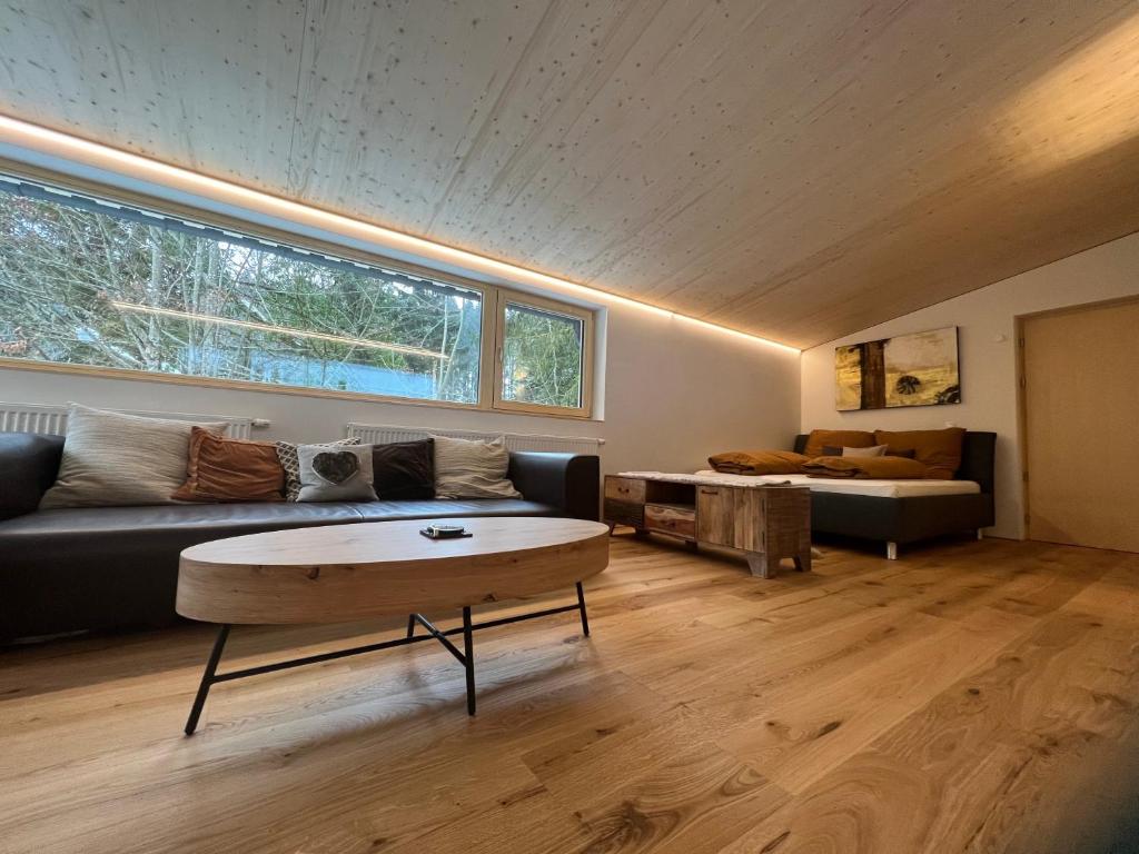 ein Wohnzimmer mit einem Sofa und einem Tisch in der Unterkunft River Lodge in Dornbirn